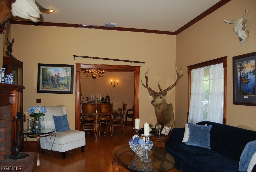 3480 4th Avenue Southeast Naples, FL 34117 - Photo 13 of 15 a living room with furniture and wooden floor