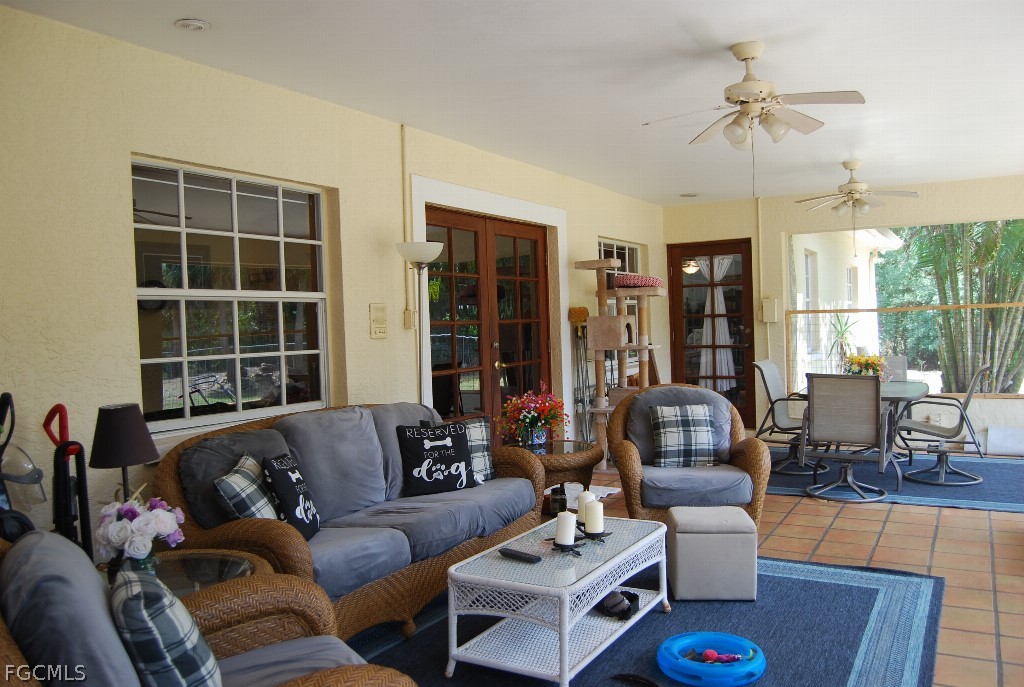 3480 4th Avenue Southeast Naples, FL 34117 - Photo 2 of 15 a living room with furniture and a large window
