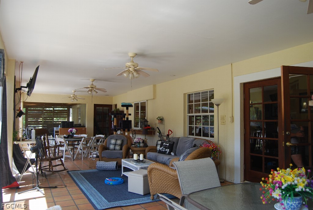 3480 4th Avenue Southeast Naples, FL 34117 - Photo 4 of 15 a living room with furniture and potted plant