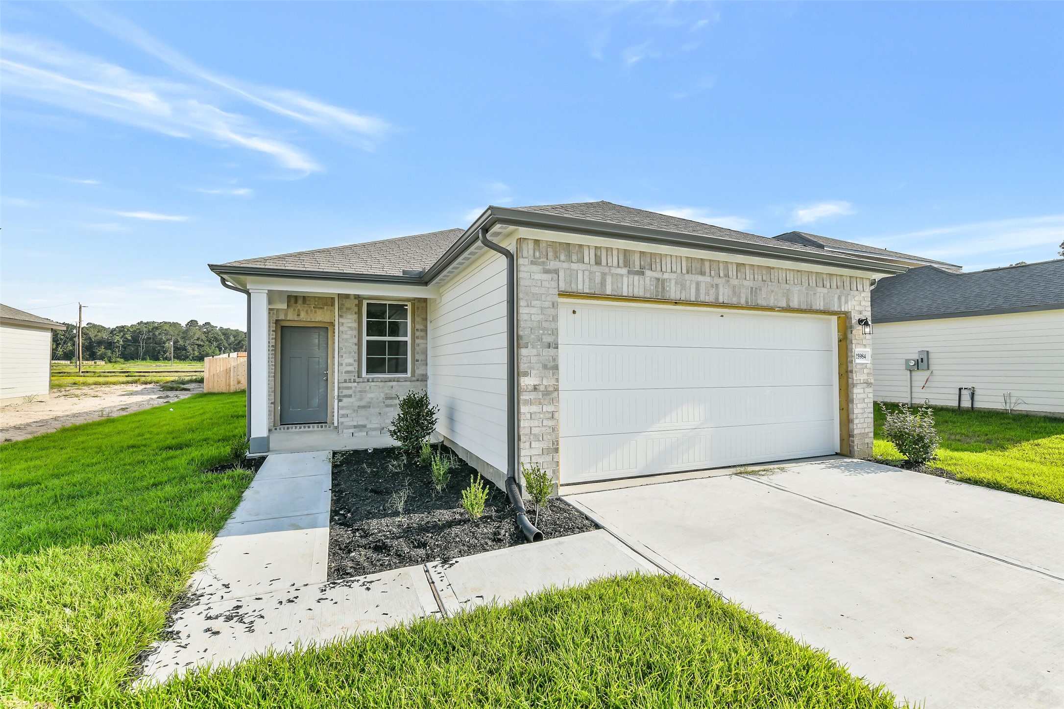 25984 Liberation Road Cleveland, TX 77328 - Photo 1 of 35 a front view of a house with garden