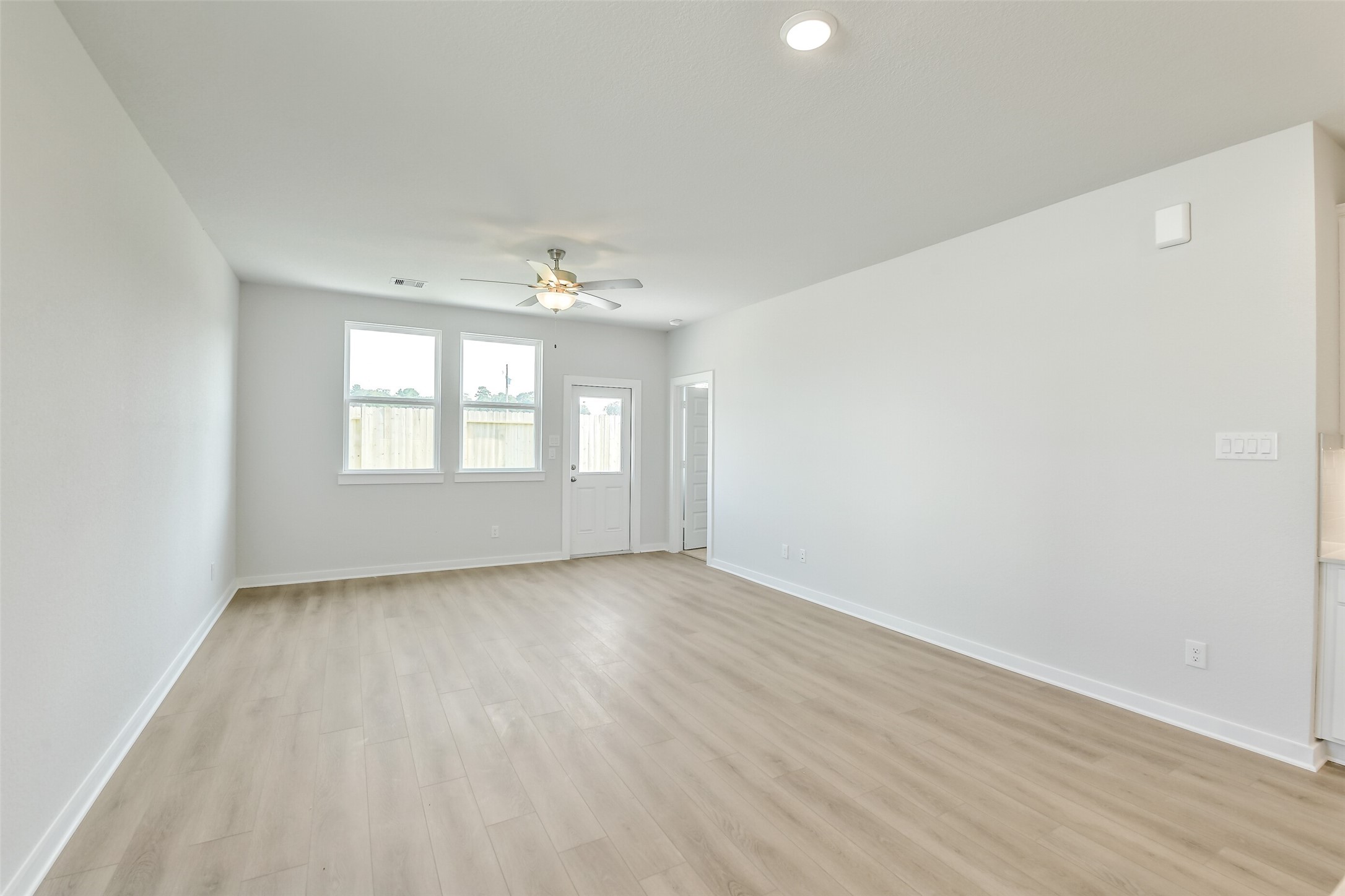 25984 Liberation Road Cleveland, TX 77328 - Photo 13 of 35 an empty room with wooden floor and windows