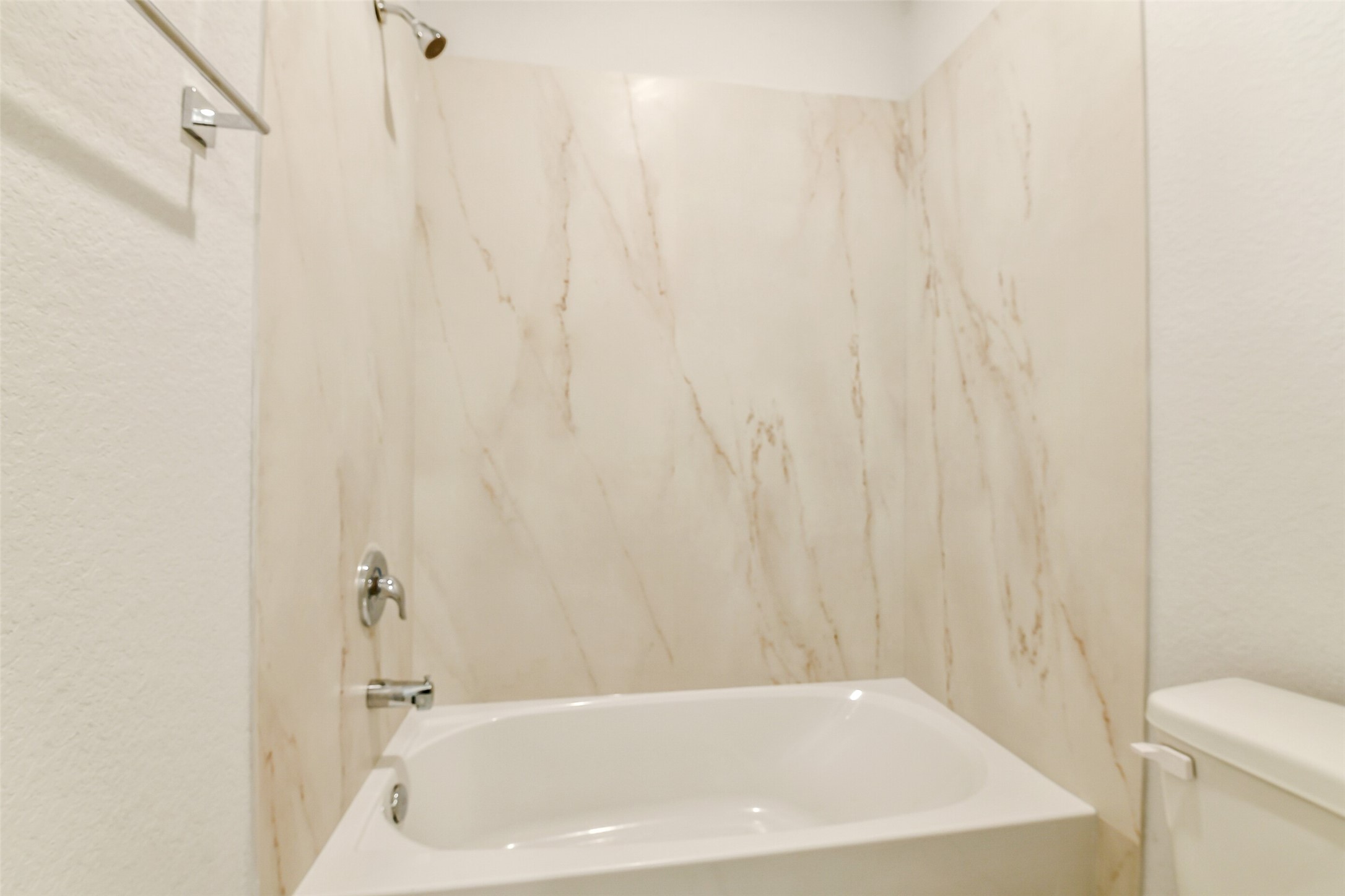 25984 Liberation Road Cleveland, TX 77328 - Photo 25 of 35 a bathroom with a white bath tub and a shower curtain