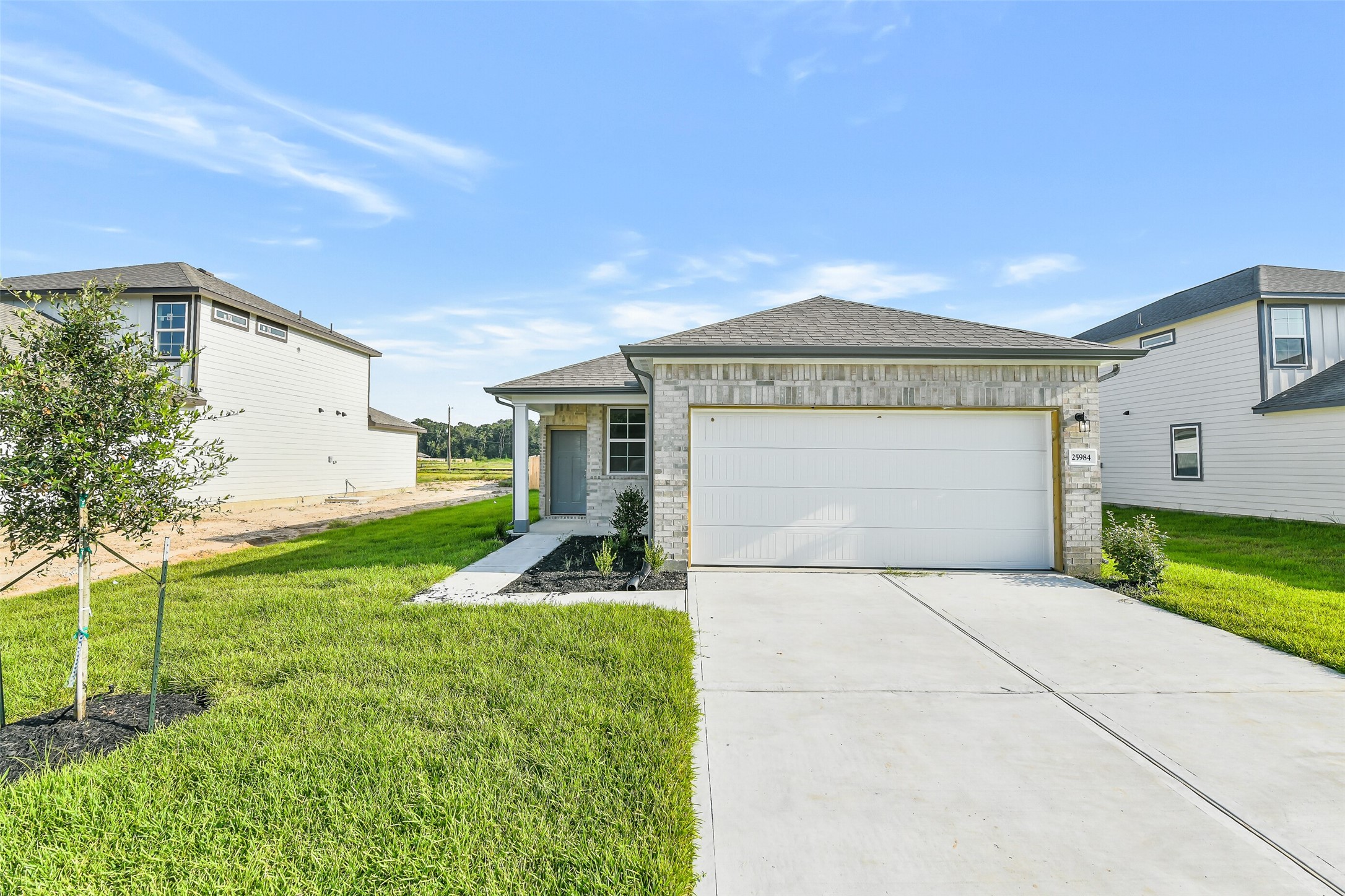 25984 Liberation Road Cleveland, TX 77328 - Photo 5 of 35 a front view of a house with garden