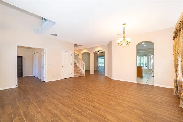 a view of a livingroom with wooden floor and a ceiling fan