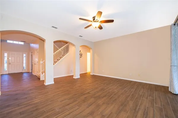 a kitchen with stainless steel appliances granite countertop a stove top oven a refrigerator a sink and dishwasher with white cabinets