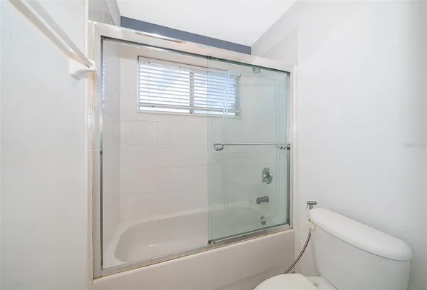 a view of room with window and ceiling fan