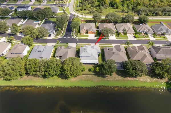 an aerial view of a house with yard swimming pool and outdoor seating