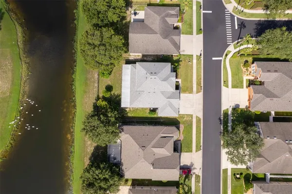 an aerial view of a house with a yard basket ball court and outdoor seating