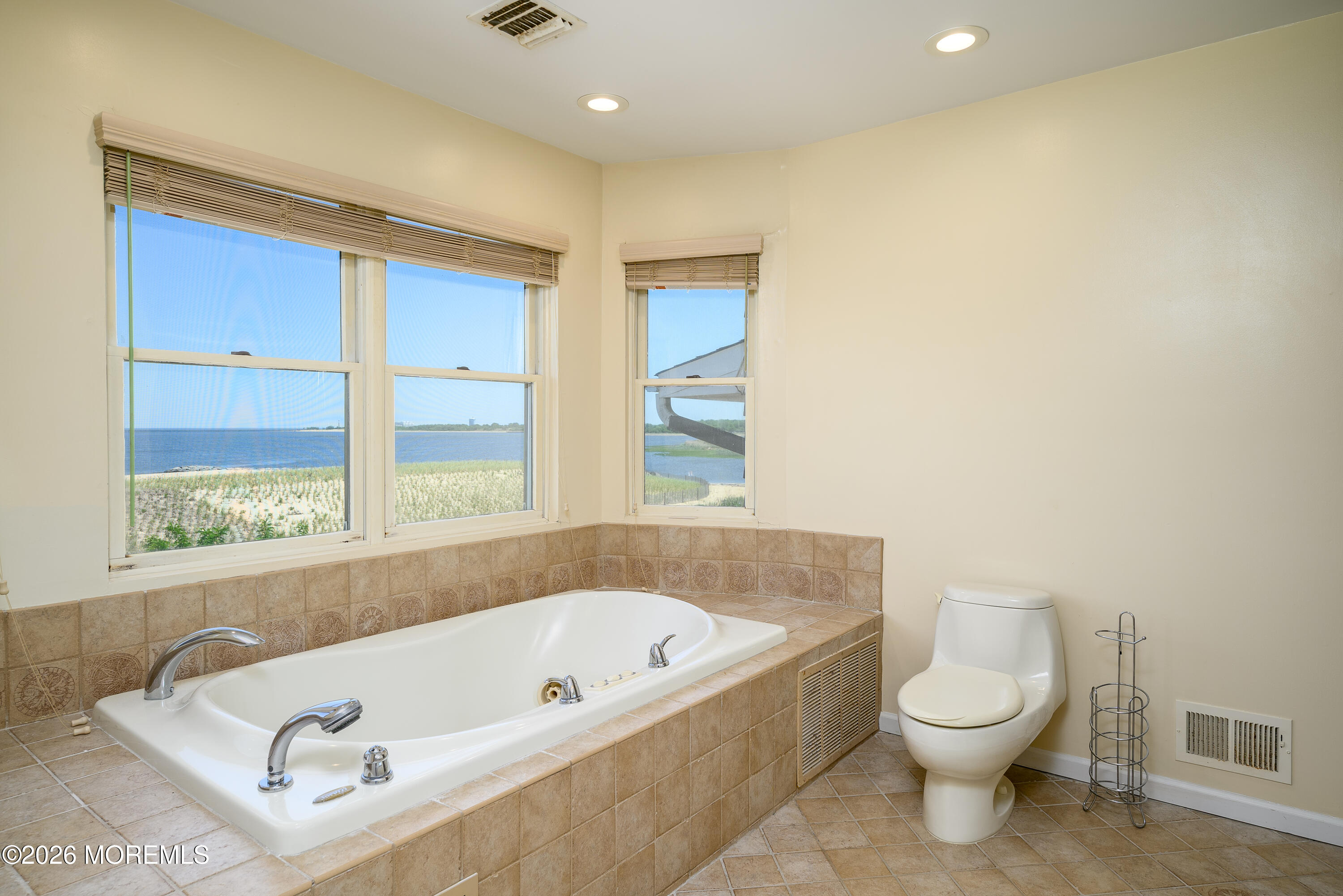 805 Front Street Union Beach, NJ 07735 - Photo 22 of 65 a bathroom with a tub a toilet and a window