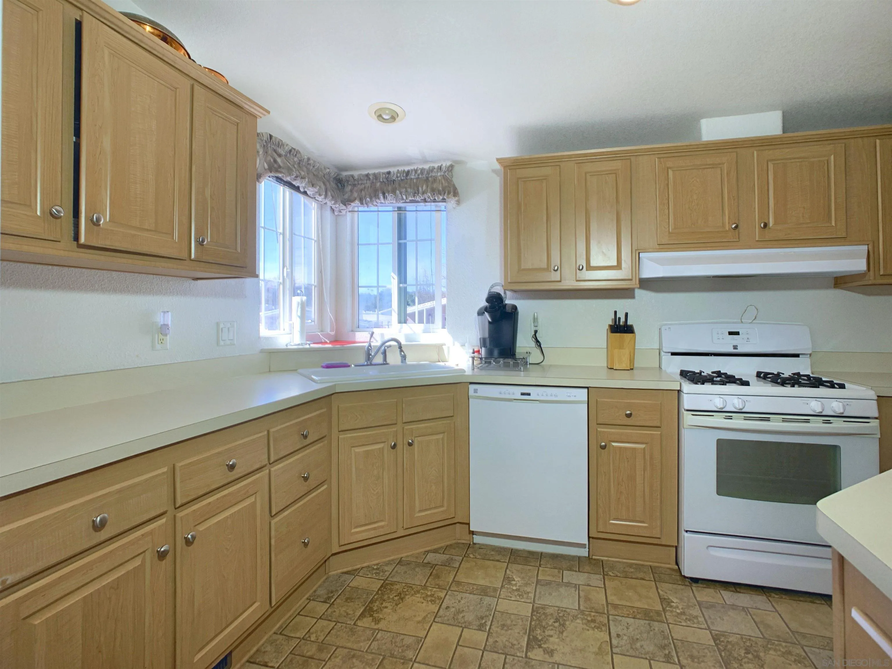 3505 Alpine Boulevard, Unit 57 Alpine, CA 91901 - Photo 11 of 28 The kitchen offers a Dishwasher, Refrigerator, Disposal, Propane Range/Oven and a countertop Microwave.