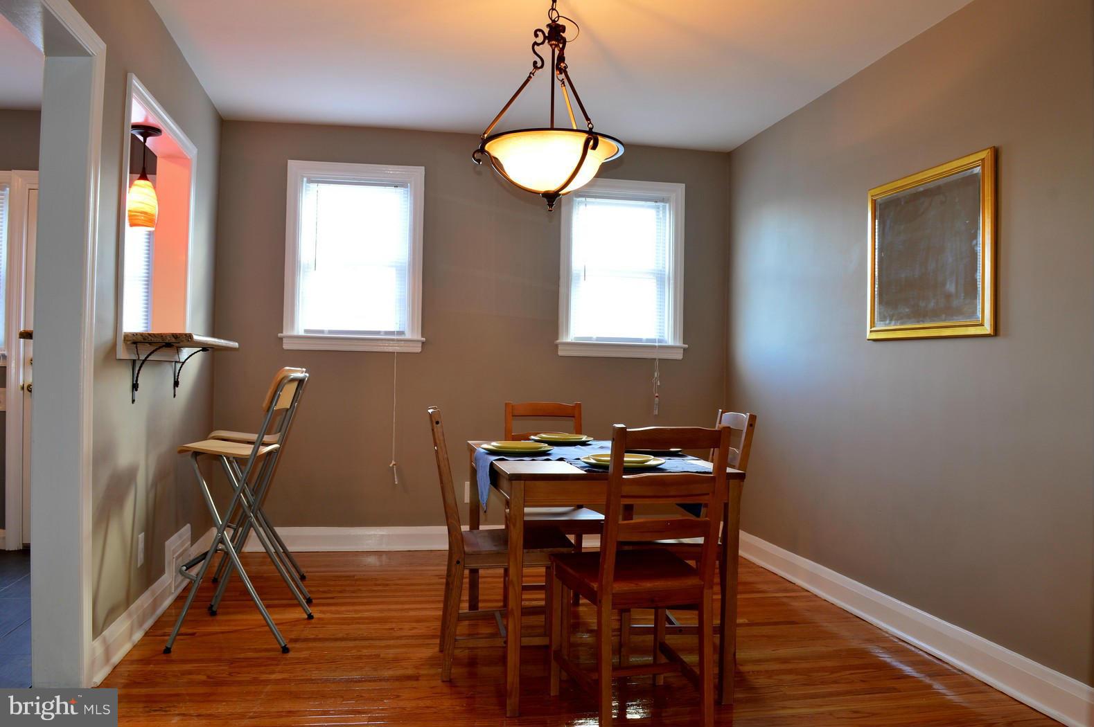 5019 West Hills Road Baltimore, MD 21229 - Photo 13 of 30 a view of a dining room with furniture and a window