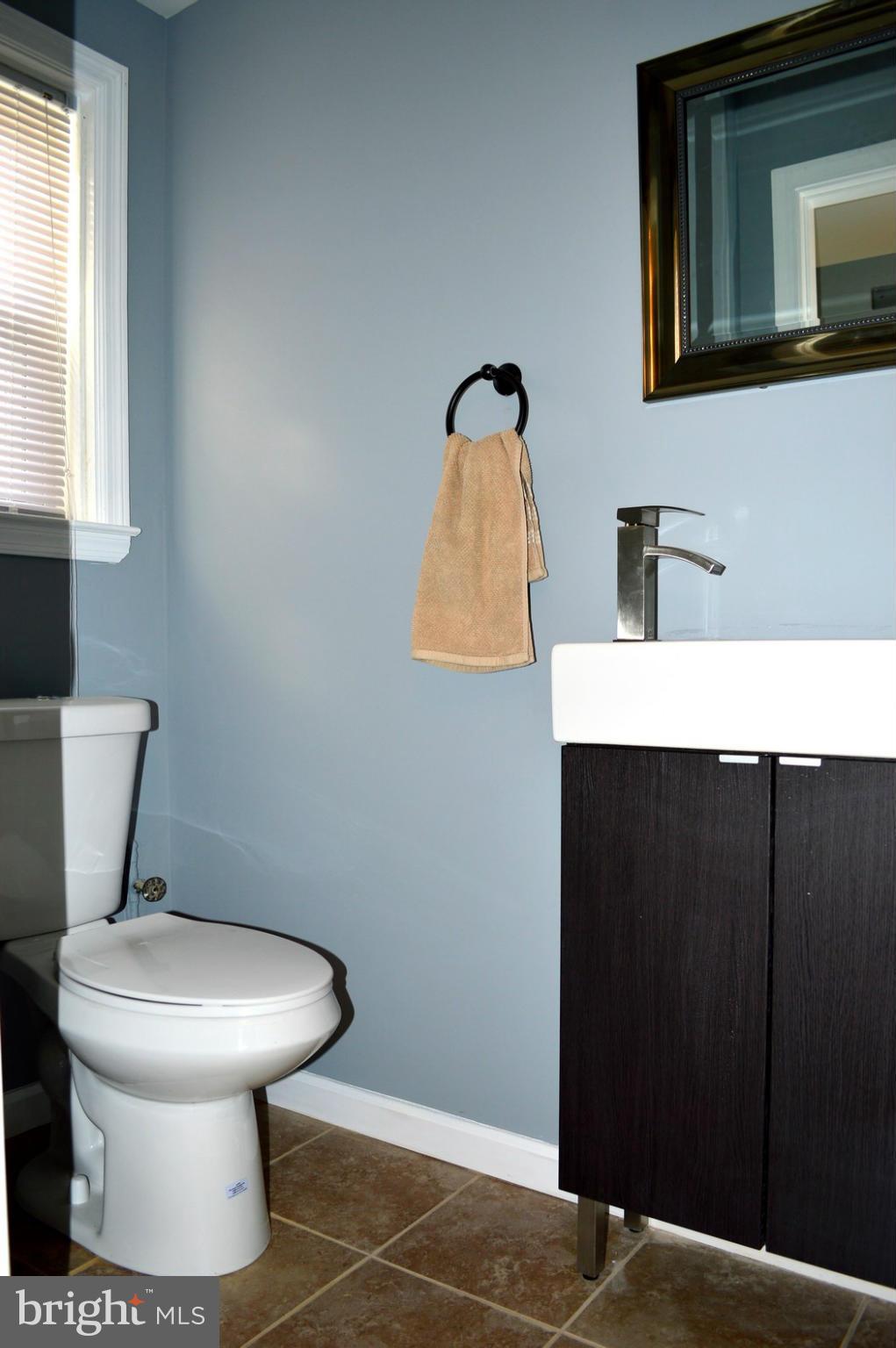 5019 West Hills Road Baltimore, MD 21229 - Photo 22 of 30 a bathroom with a toilet and a sink