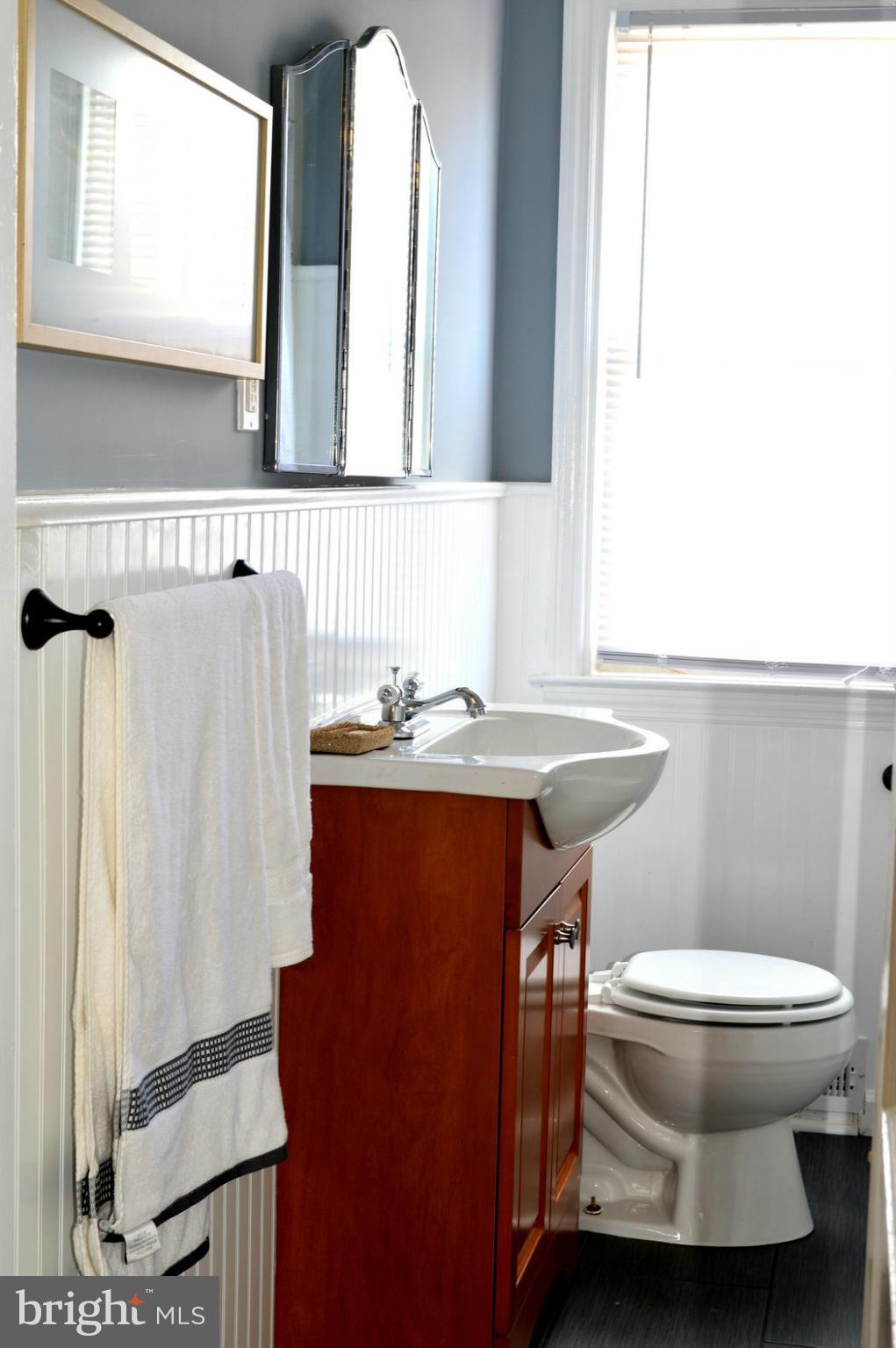 5019 West Hills Road Baltimore, MD 21229 - Photo 26 of 30 a bathroom with a sink toilet and mirror
