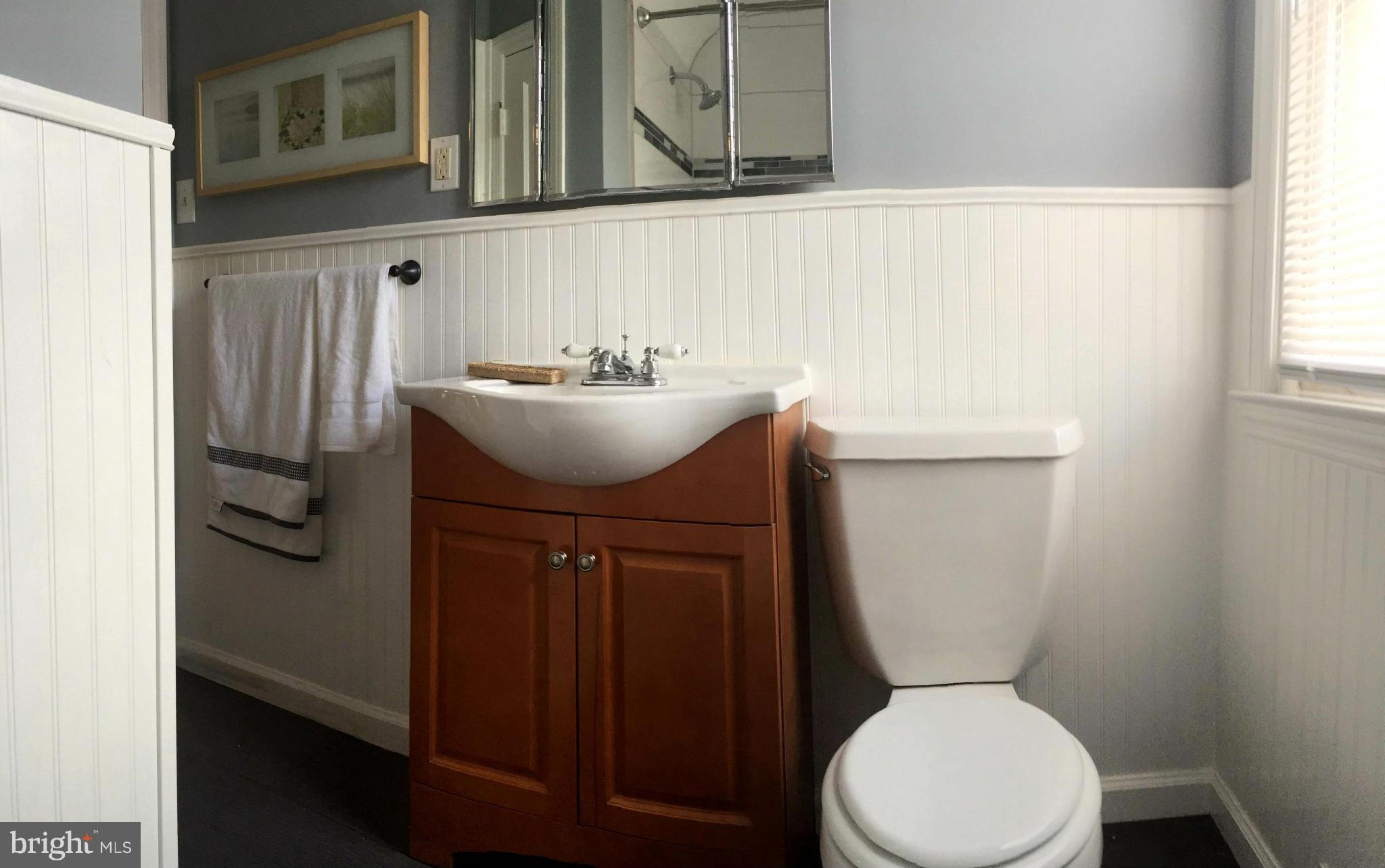 5019 West Hills Road Baltimore, MD 21229 - Photo 28 of 30 a bathroom with a toilet sink and mirror