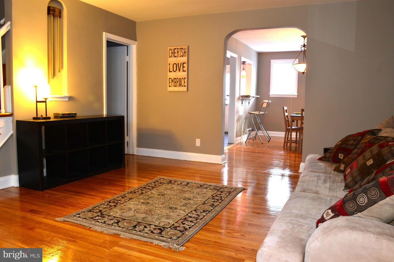 5019 West Hills Road Baltimore, MD 21229 - Photo 4 of 30 a view of a bedroom with wooden floor and bathroom