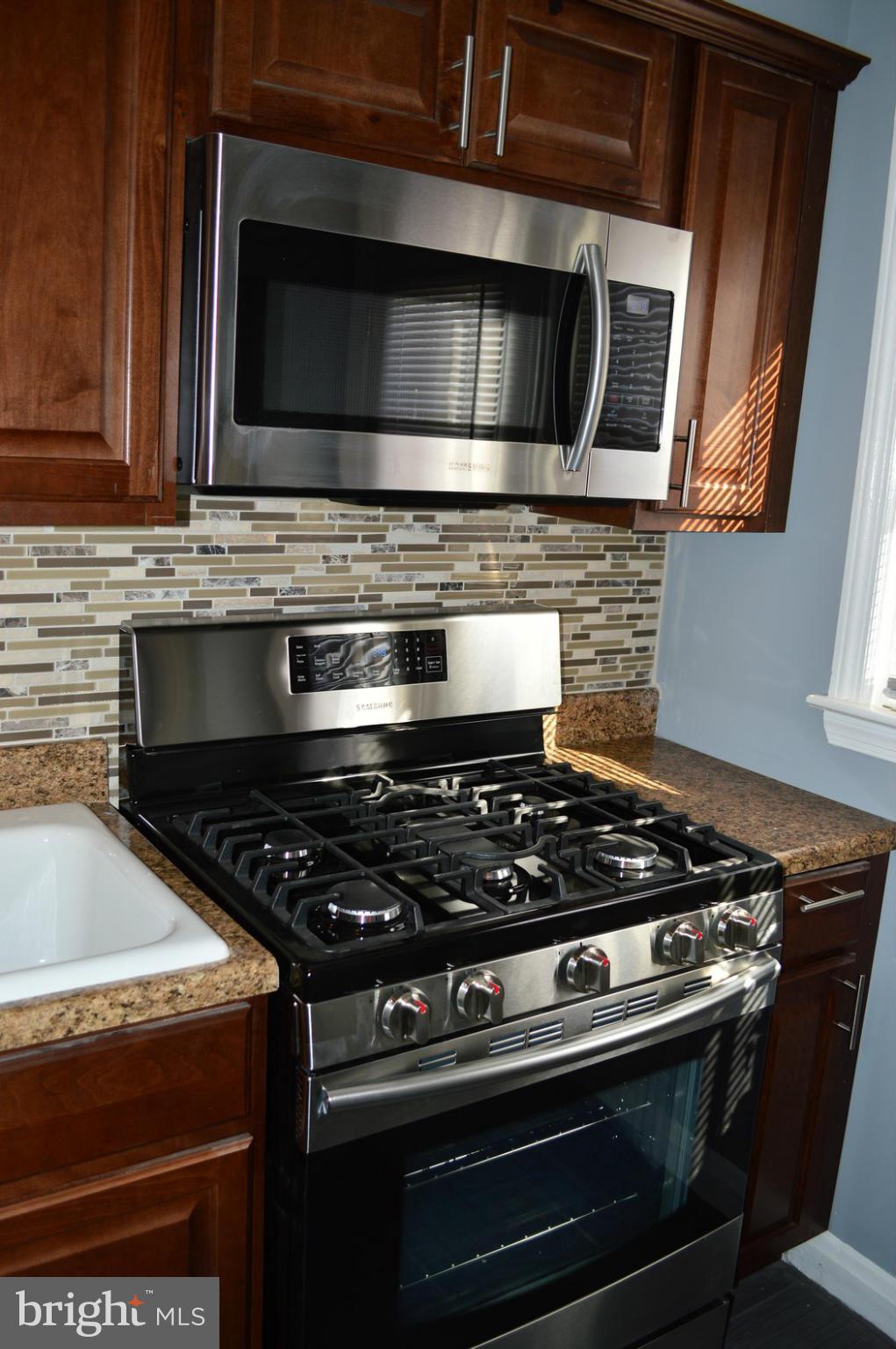 5019 West Hills Road Baltimore, MD 21229 - Photo 10 of 30 a stove top oven sitting inside of a kitchen