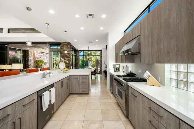 a large kitchen with stainless steel appliances lots of counter space and wooden floor