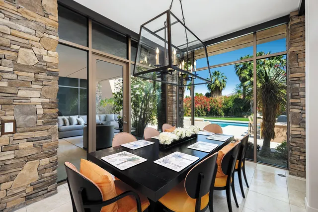 a view of an outdoor dining space with a table and chairs