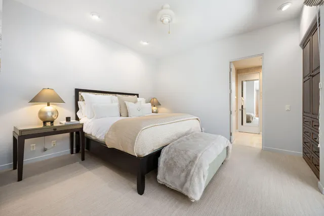 a bedroom with a bed and a lamp on table