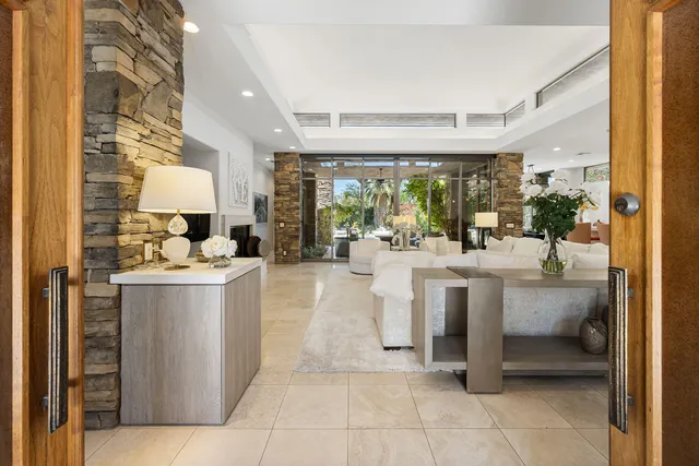 a view of living room with stainless steel appliances kitchen island granite countertop furniture and a view of living room