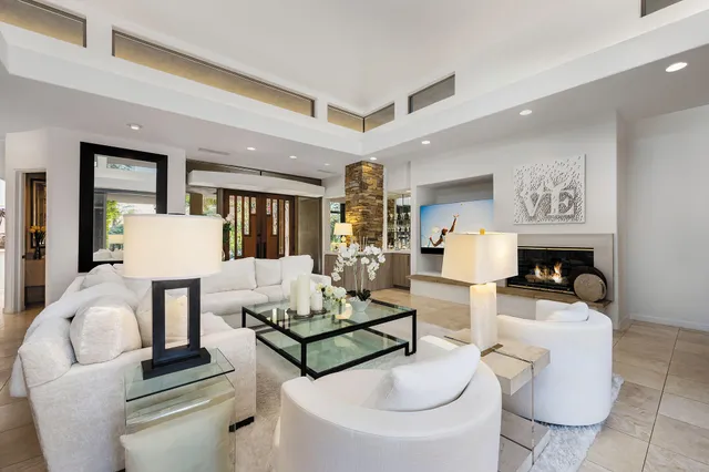 a living room with fireplace furniture and a wooden floor