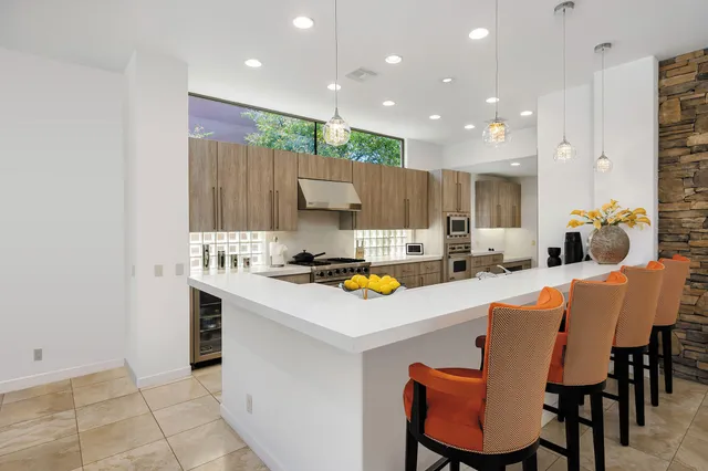 a kitchen that has a table and chairs in it