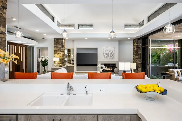 an outdoor living room with furniture and a large window