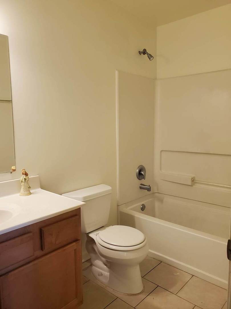833 Village Quarter Road, Unit G4 West Dundee, IL 60118 - Photo 13 of 15 a bathroom with a sink a toilet and shower