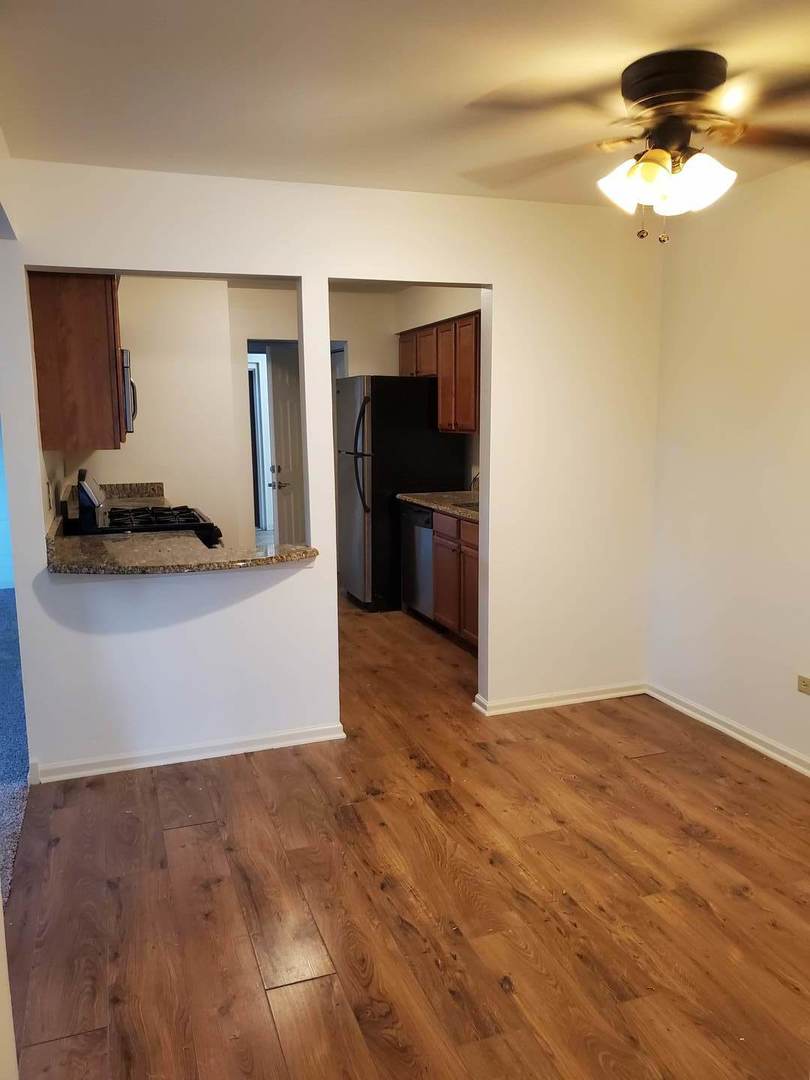 833 Village Quarter Road, Unit G4 West Dundee, IL 60118 - Photo 8 of 15 a view of a livingroom with a flat screen tv