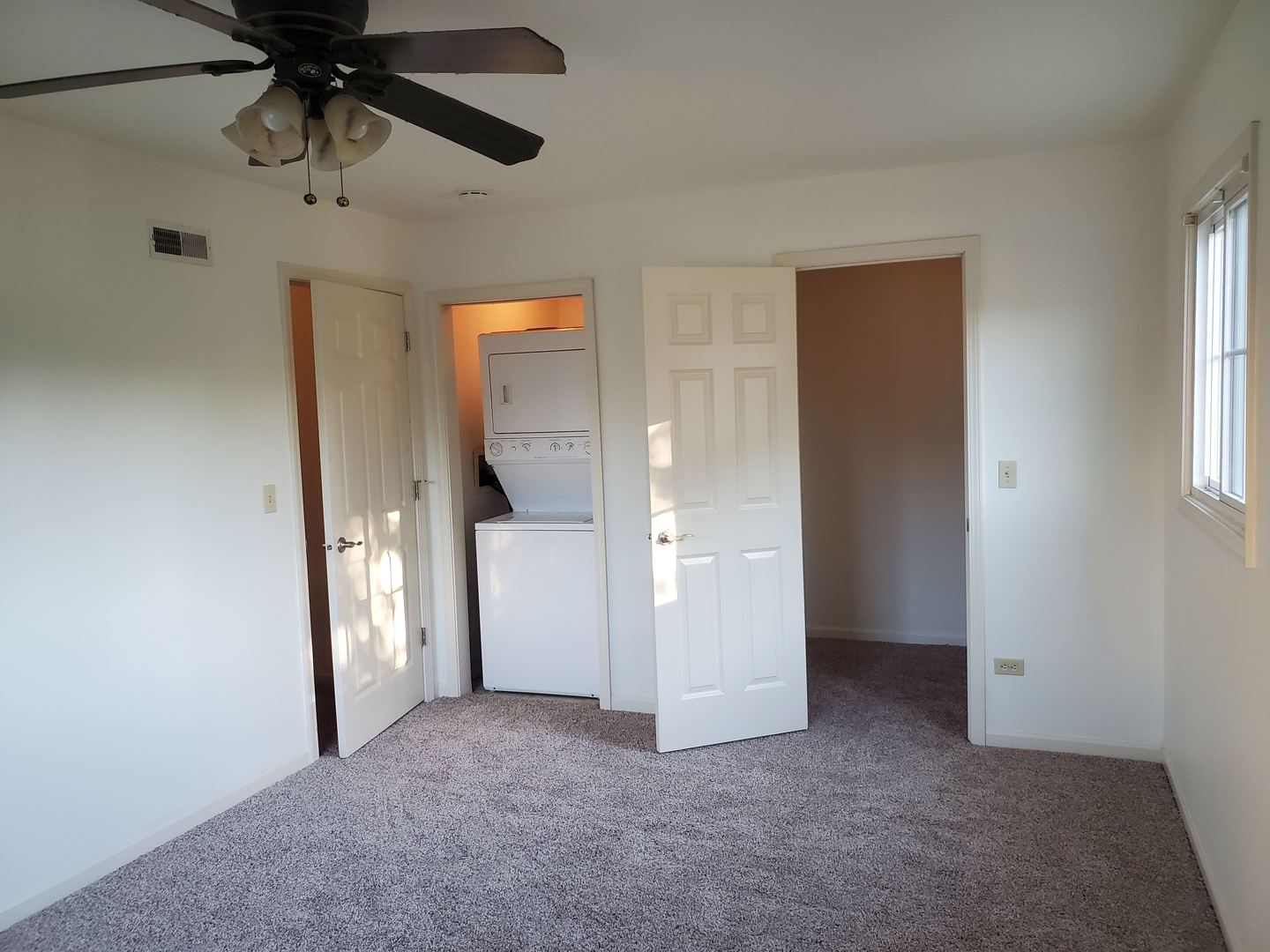 833 Village Quarter Road, Unit G4 West Dundee, IL 60118 - Photo 9 of 15 an empty room that has a window and a ceiling fan