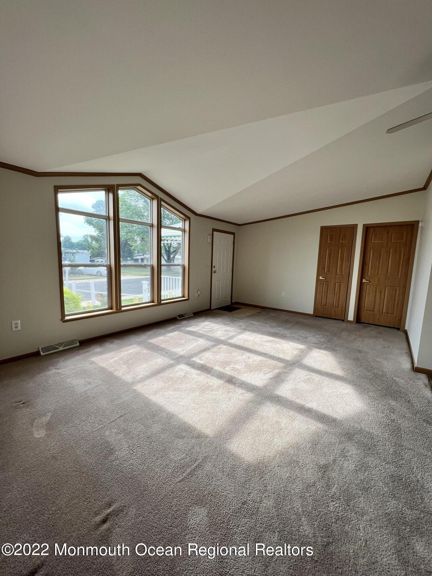 123 Woody Road Freehold, NJ 07728 - Photo 4 of 19 an empty room with a empty space and windows