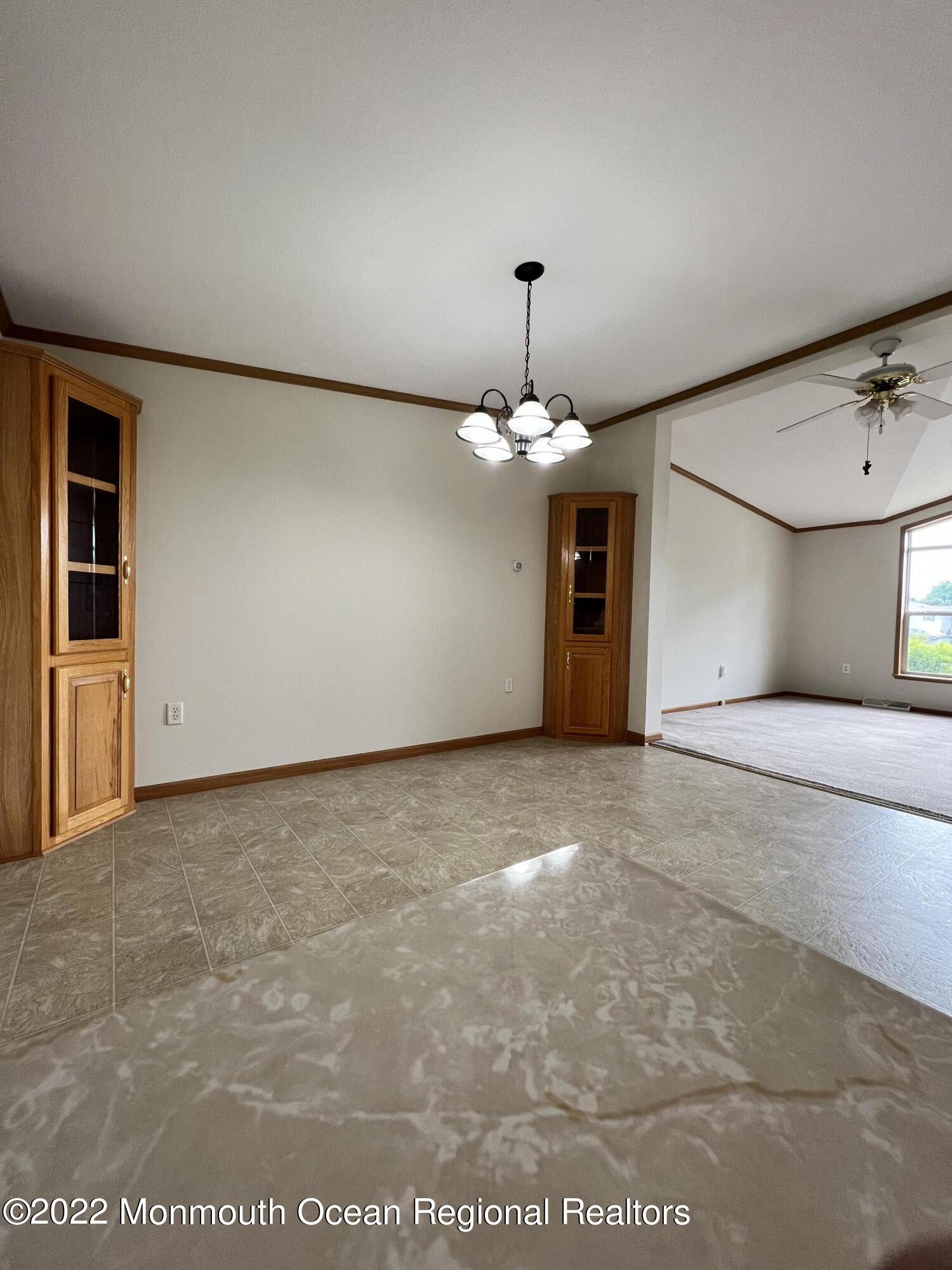 123 Woody Road Freehold, NJ 07728 - Photo 6 of 19 a view of a livingroom with a chandelier