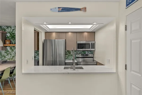 a view of a hallway with dining area