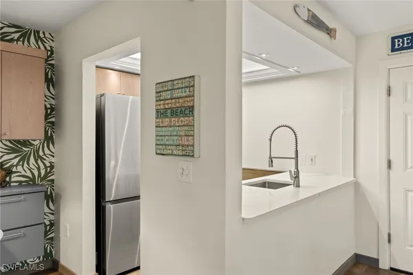a close view of a sink and a refrigerator in a kitchen