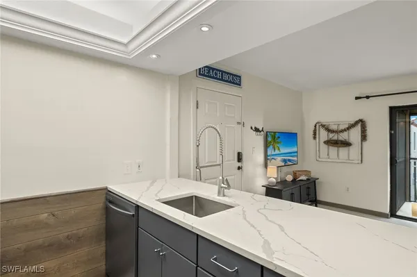 a kitchen with a sink and a stove top oven