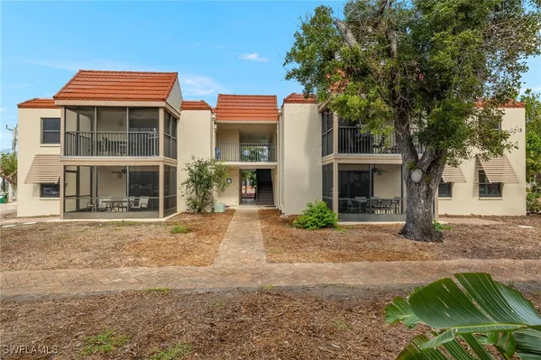 a front view of a house with a yard and a garage