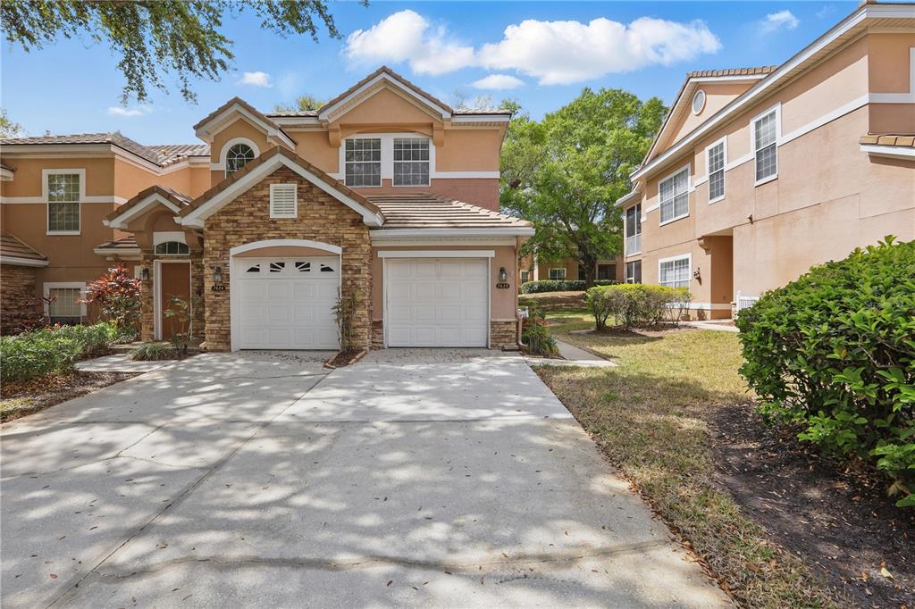 7620 Bayport Road, Unit 39 Orlando, FL 32819 - Photo 1 of 1 a front view of a house with a yard