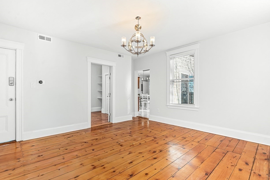 11 Symonds Street, Unit 2 Salem, MA 01970 - Photo 17 of 30 a view of an empty room with wooden floor and a window
