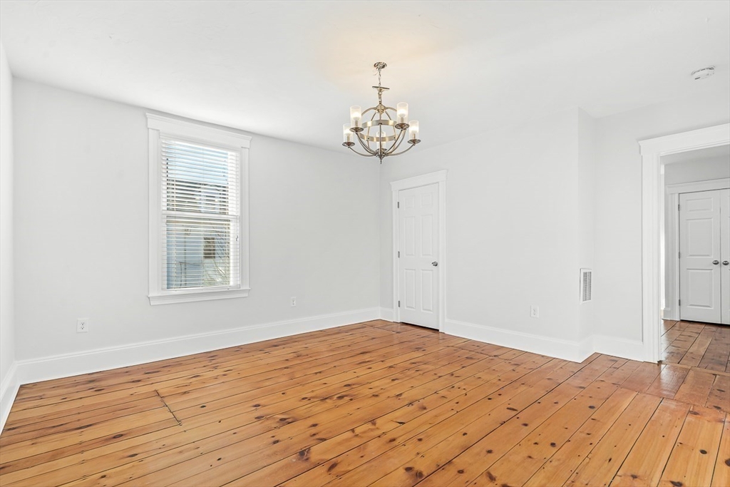 11 Symonds Street, Unit 2 Salem, MA 01970 - Photo 18 of 30 a view of a room with wooden floor and a chandelier fan