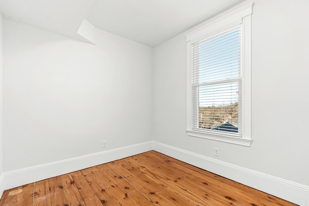 11 Symonds Street, Unit 2 Salem, MA 01970 - Photo 20 of 30 an empty room with wooden floor and windows