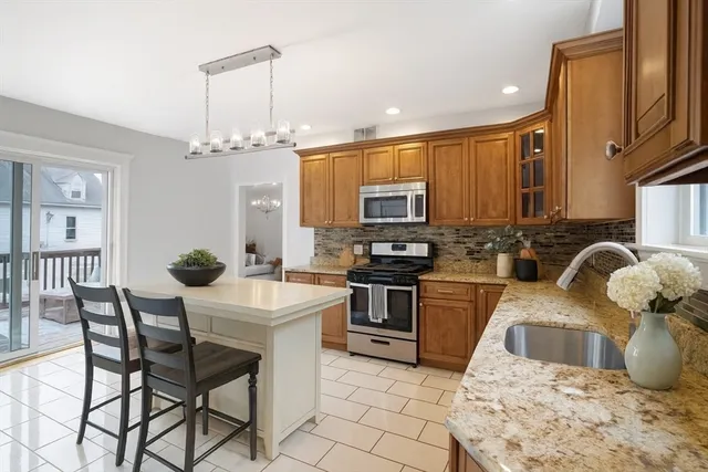 a kitchen with stainless steel appliances kitchen island granite countertop a sink and cabinets
