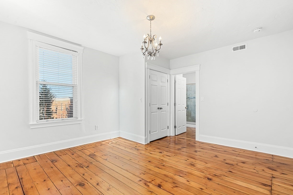11 Symonds Street, Unit 2 Salem, MA 01970 - Photo 22 of 30 a view of a room with wooden floor and chandelier