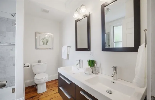 a bathroom with a toilet sink and mirror