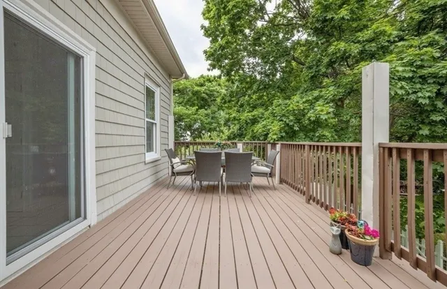 a view of balcony with wooden floor and outdoor seating