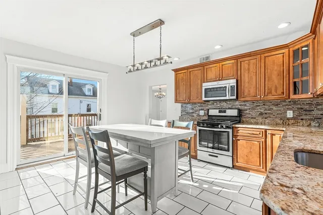 a bathroom with a granite countertop sink a toilet and shower