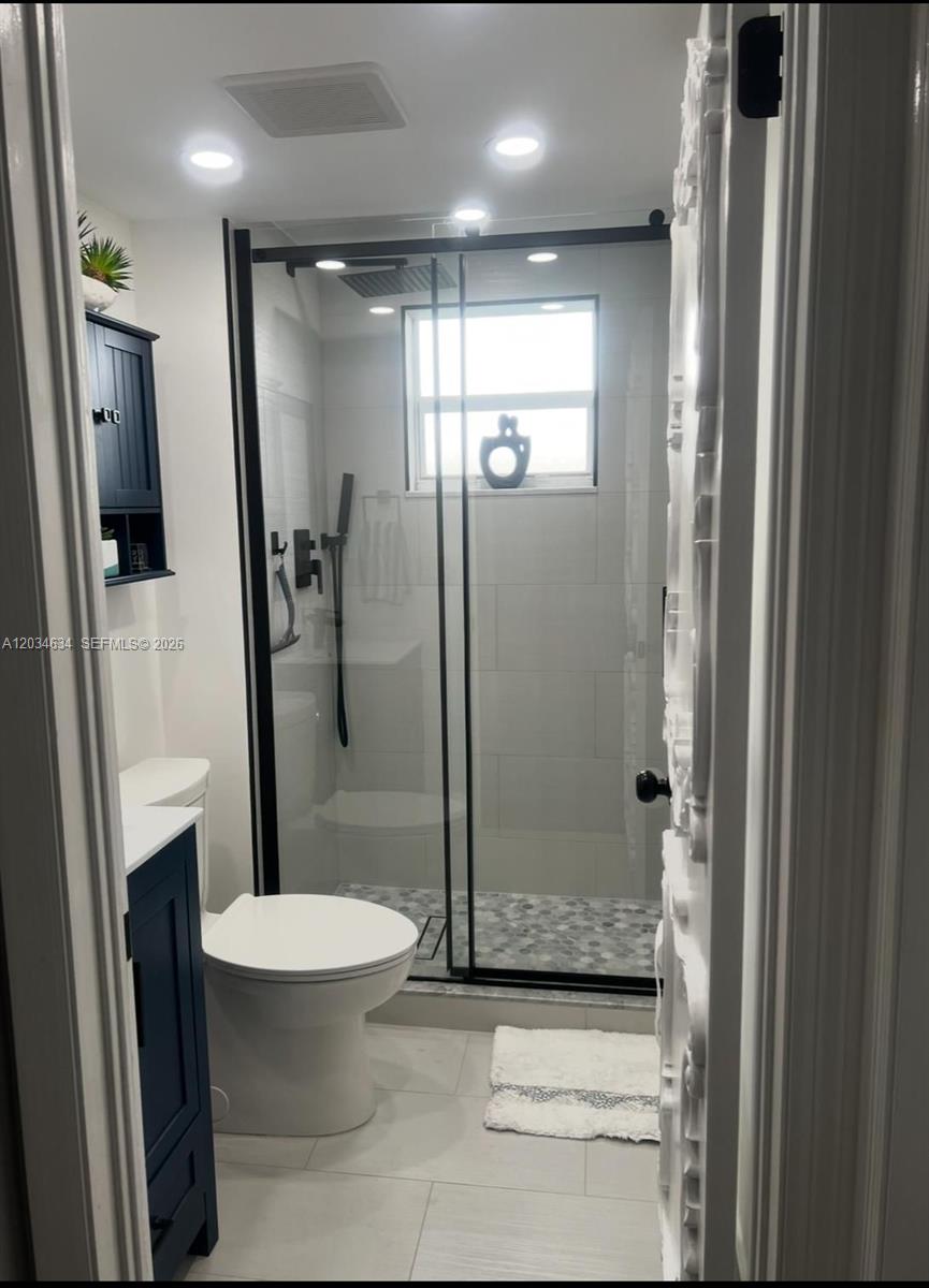 9880 Marina Boulevard, Unit 1516 Boca Raton, FL 33428 - Photo 14 of 32 a bathroom with a shower and toilet