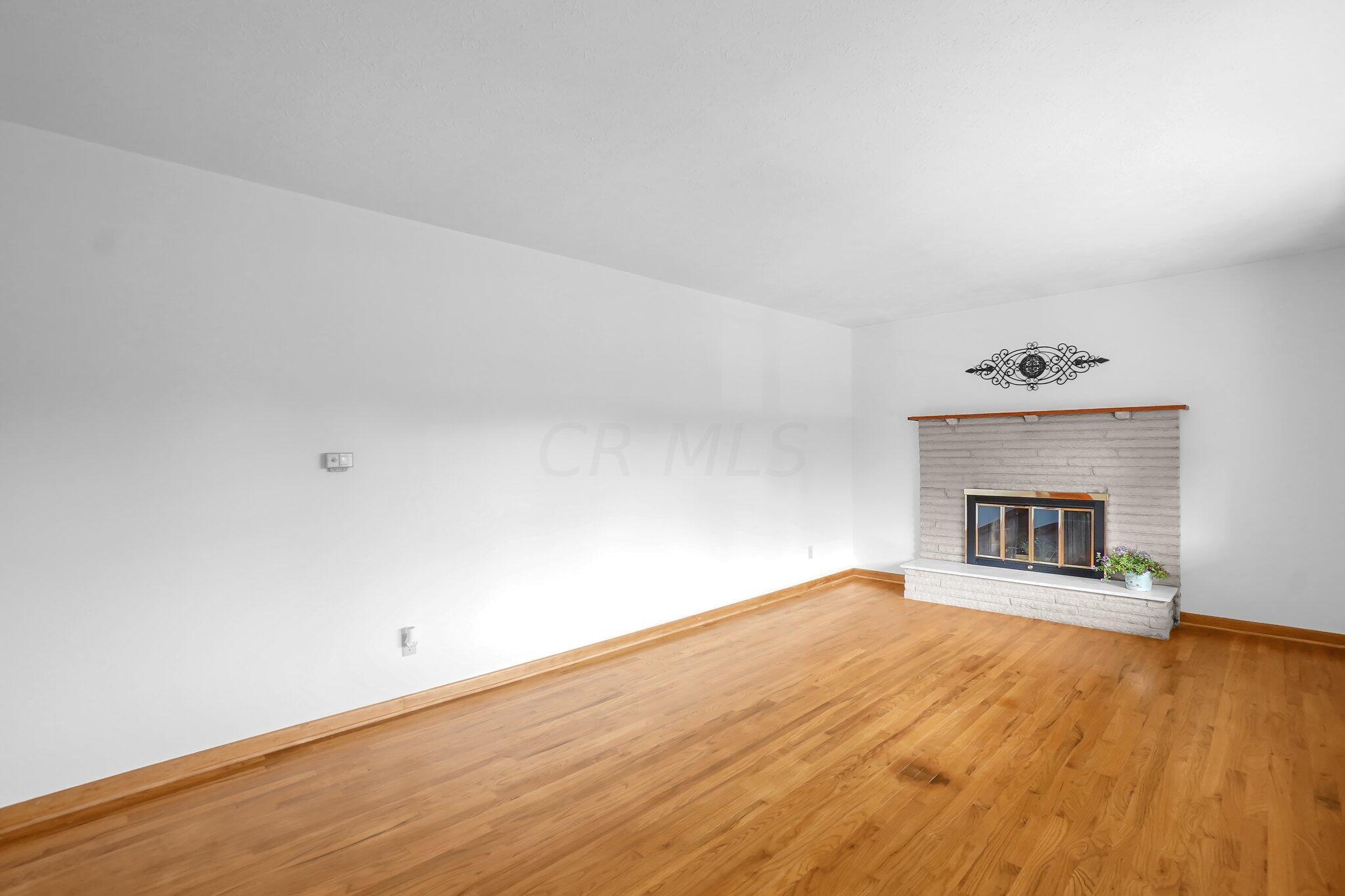 2105 Stringtown Road Northeast Lancaster, OH 43130 - Photo 20 of 45 wood floors in living room with wood burning fireplace