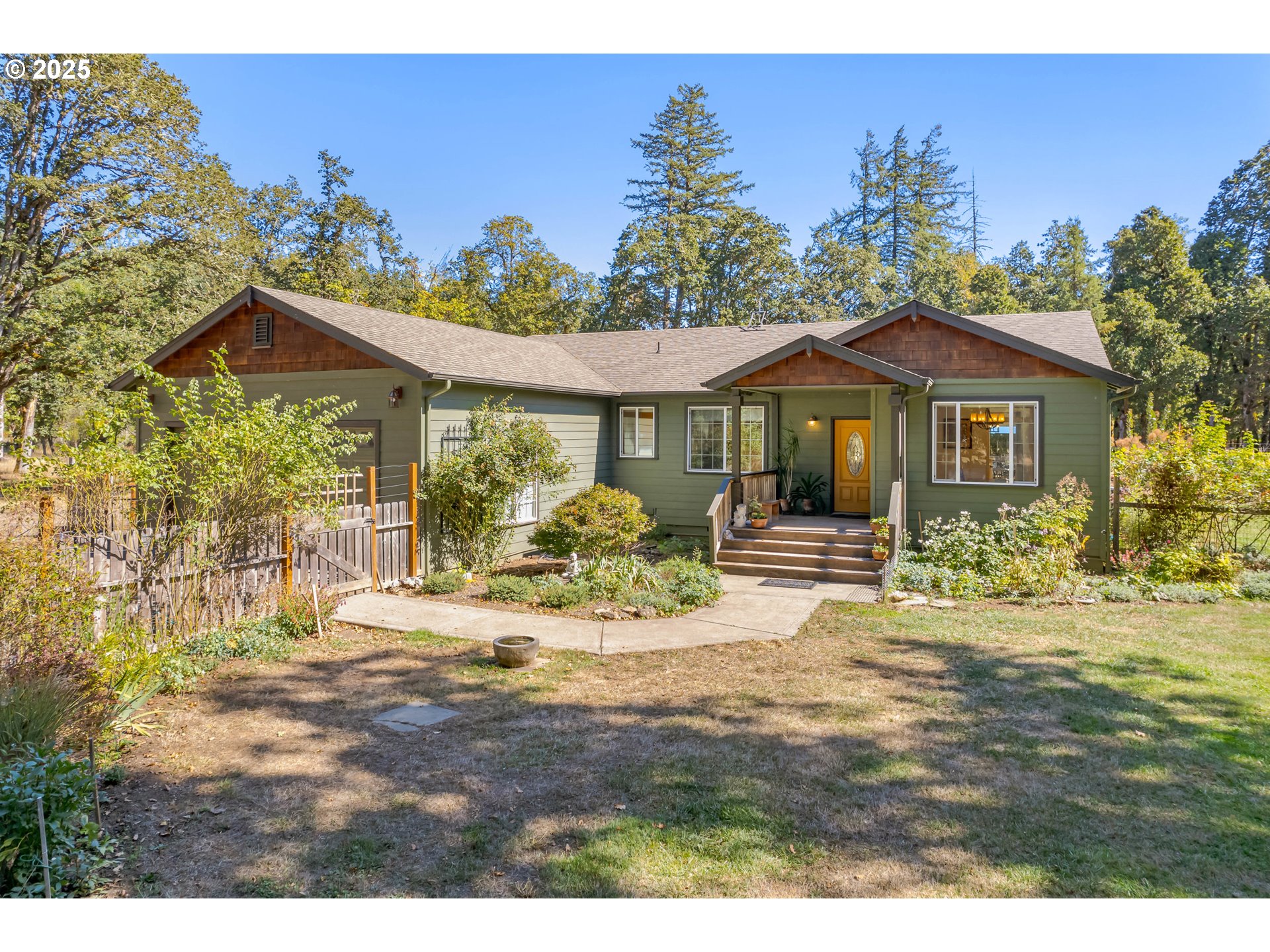 78691 Sears Road Cottage Grove, OR 97424 - Photo 1 of 48 a front view of a house with a garden