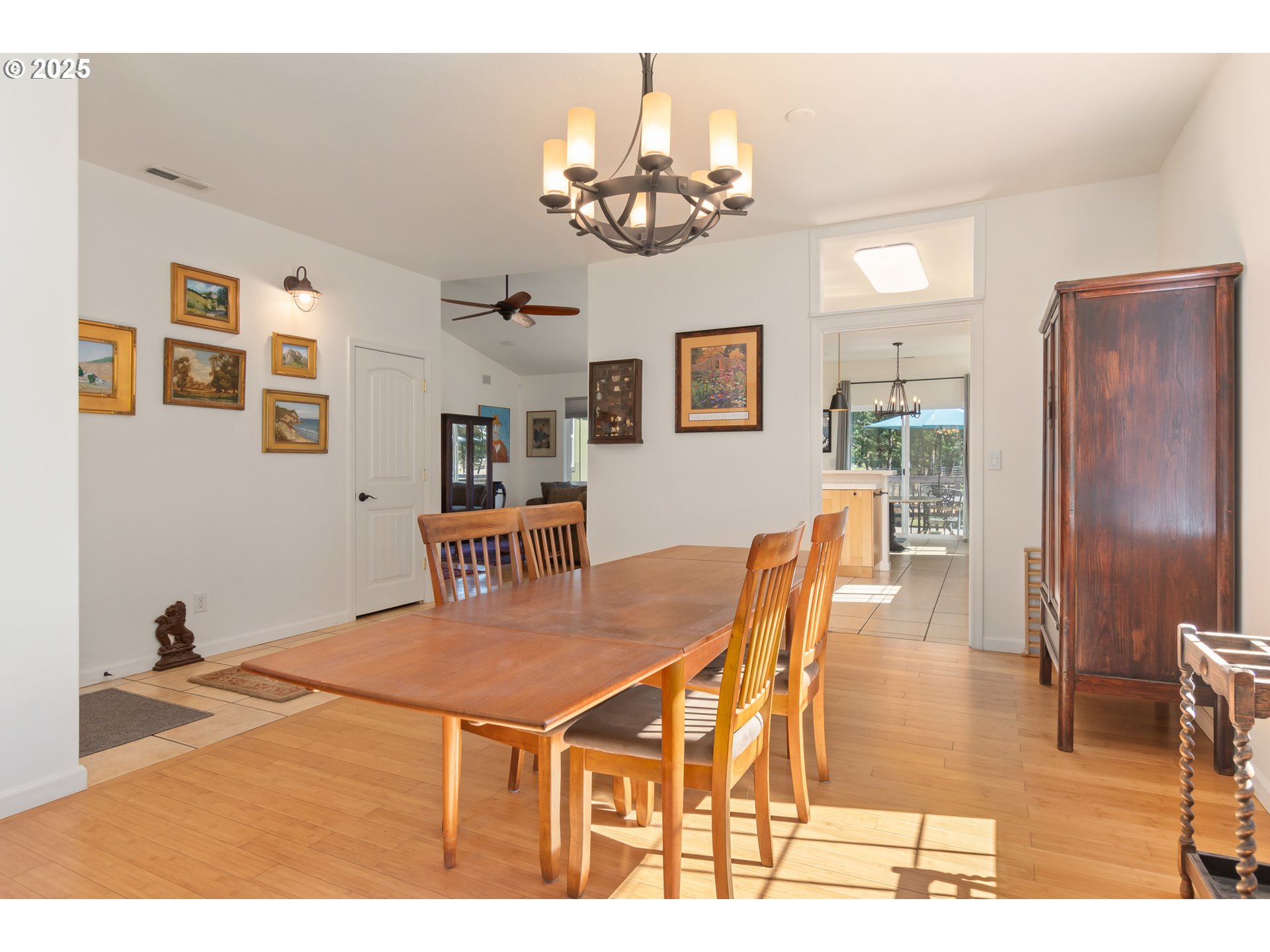 78691 Sears Road Cottage Grove, OR 97424 - Photo 14 of 48 a dining room with wooden floor and chandelier