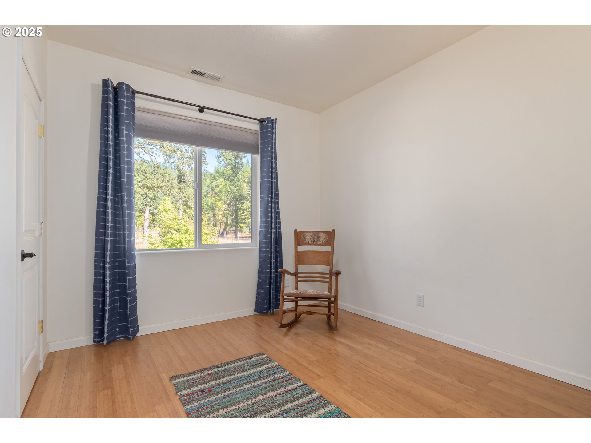 78691 Sears Road Cottage Grove, OR 97424 - Photo 23 of 48 a bedroom with a bed and a chair